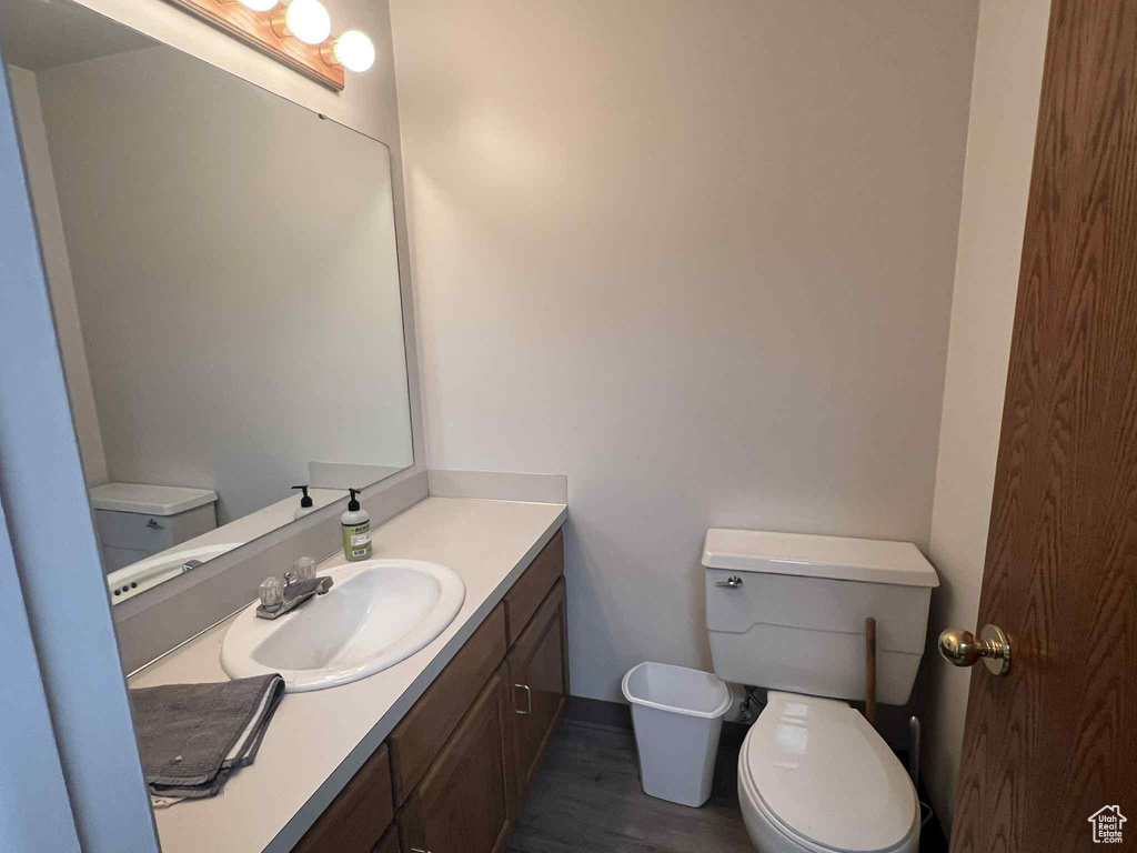 Bathroom with vanity and wood finished floors