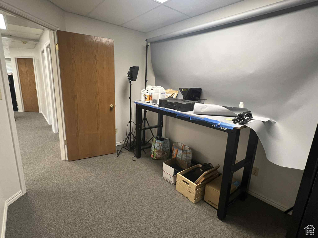 Carpeted bedroom featuring an office area