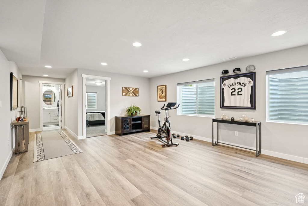 Exercise area featuring light wood-type flooring and recessed lighting