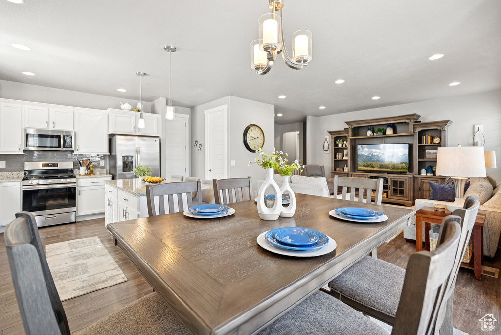 Dining room featuring recessed lighting, wood finished floors, and a chandelier