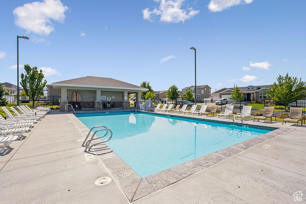 Community pool featuring a patio area and a residential view