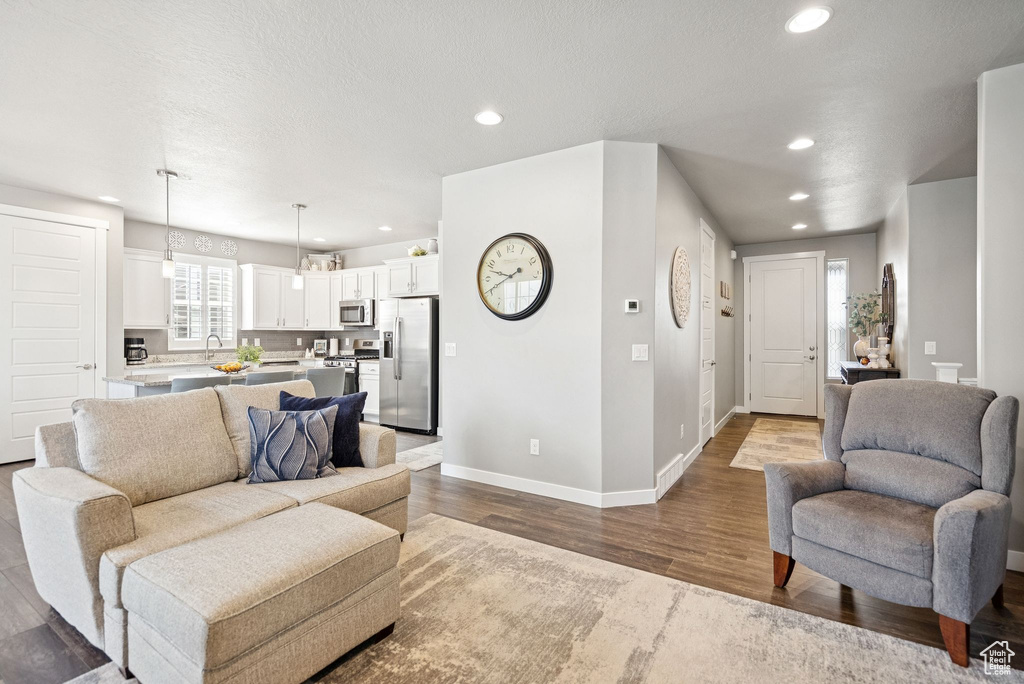 Living room featuring wood finished floors and recessed lighting