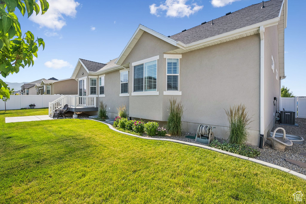View of home\\\\\\\'s exterior with stucco siding, a patio area, a deck, and a shingled roof
