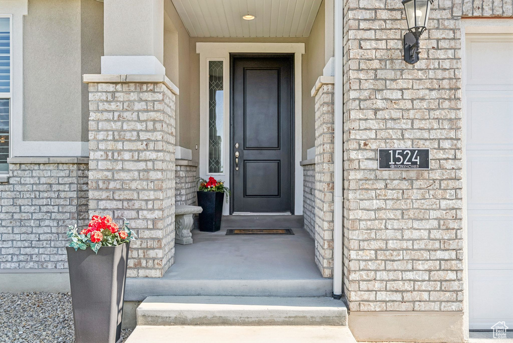 View of exterior entry featuring stucco siding