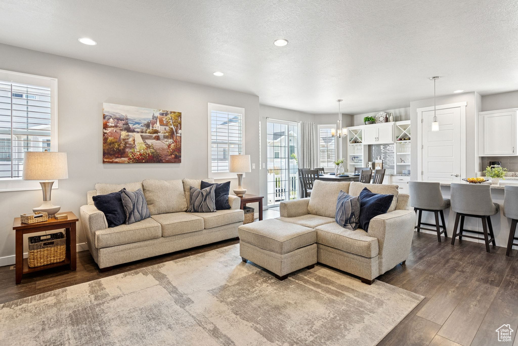 Living area featuring recessed lighting and dark wood-style floors