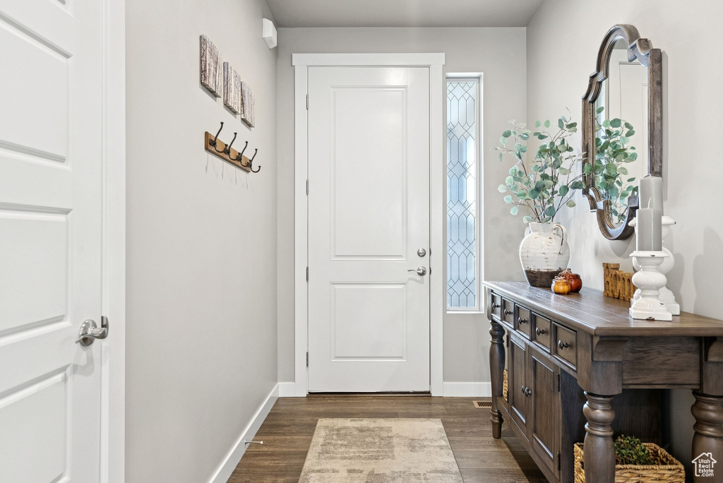 Entryway with dark wood-style floors and baseboards