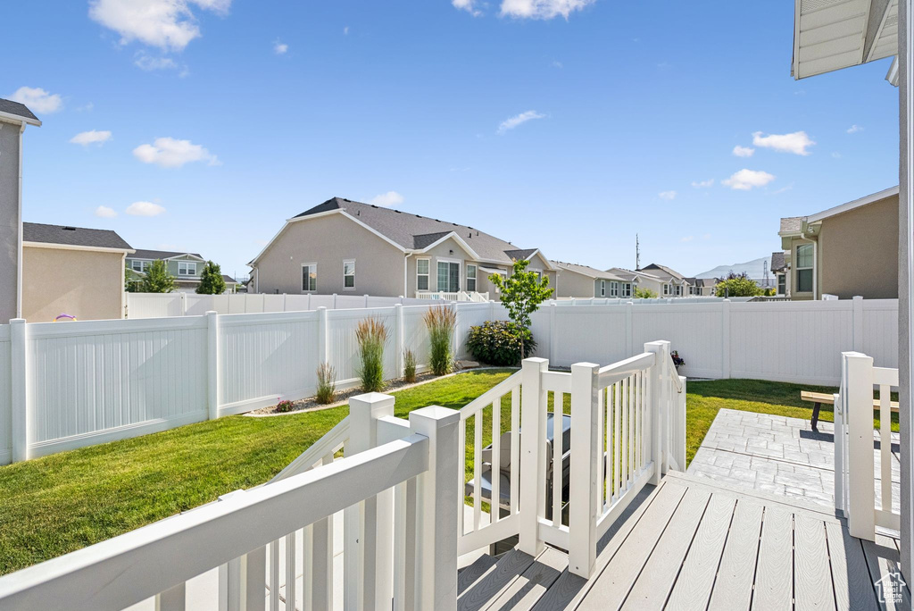 Wooden terrace with a residential view and a fenced backyard