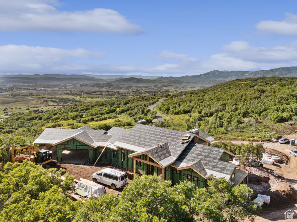 View from above of property with a forest and a mountain backdrop
