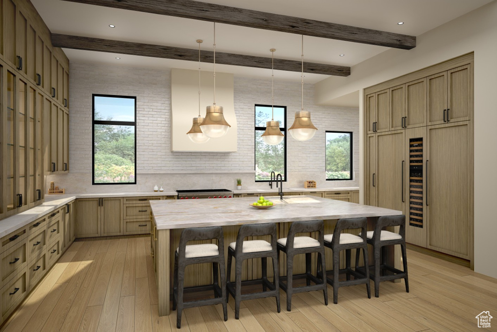 Kitchen with backsplash, beamed ceiling, a breakfast bar, light wood-type flooring, and hanging light fixtures