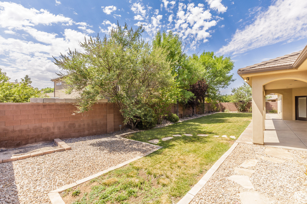 Fenced backyard with a patio