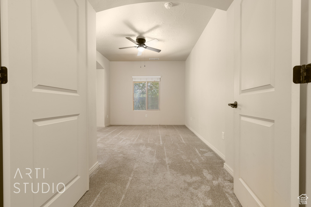 Spare room with carpet flooring, ceiling fan, a textured ceiling, and a smoke detector