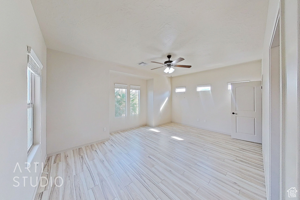 Spare room featuring a ceiling fan and light wood-style floors