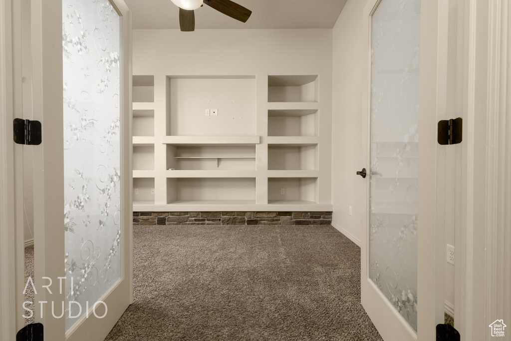 Spacious closet featuring carpet and a ceiling fan