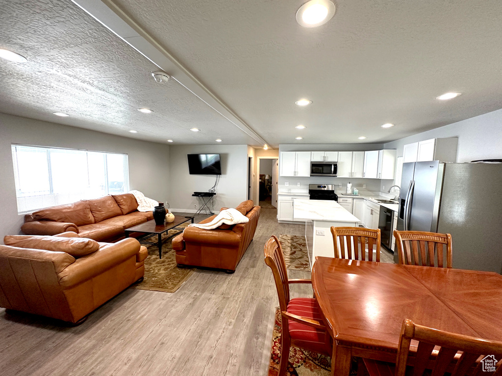 Dining room featuring light wood-type flooring and recessed lighting