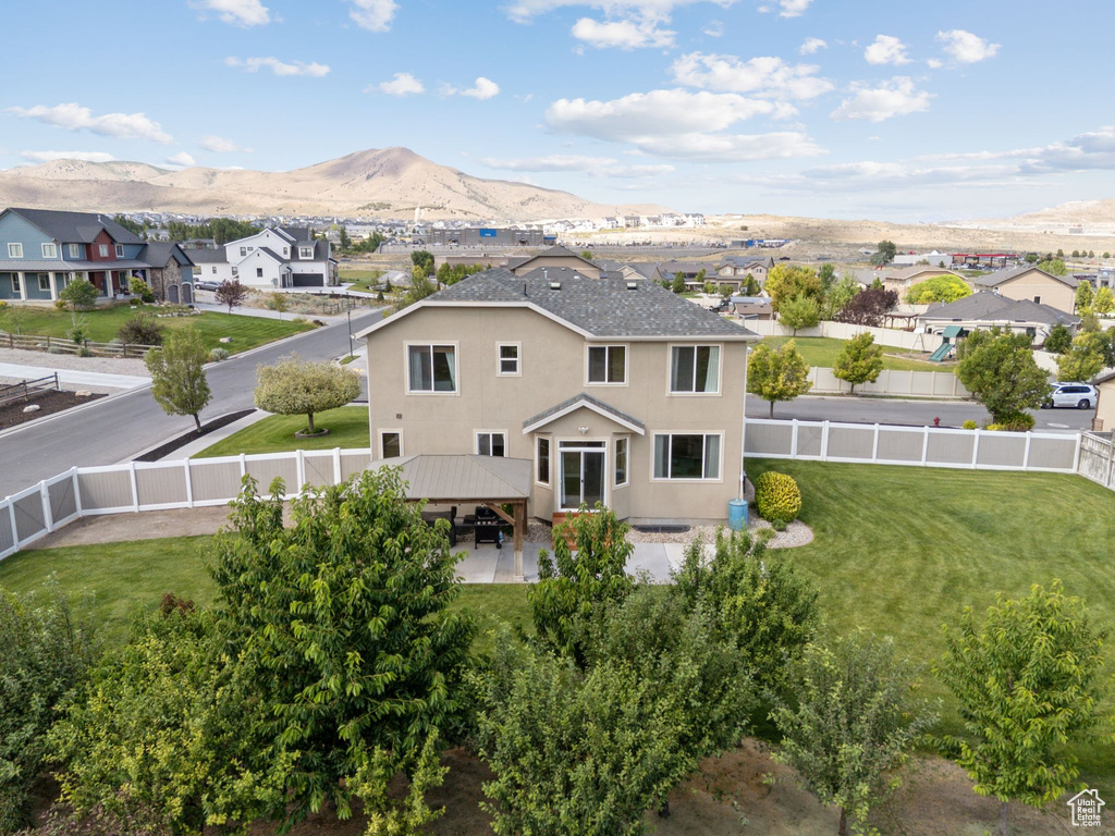 Back of house with a fenced backyard, a gazebo, and a residential view