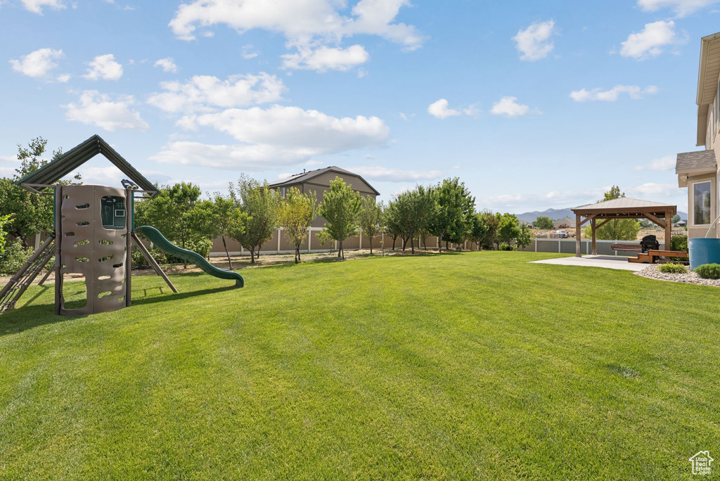 View of yard with a gazebo and a playground