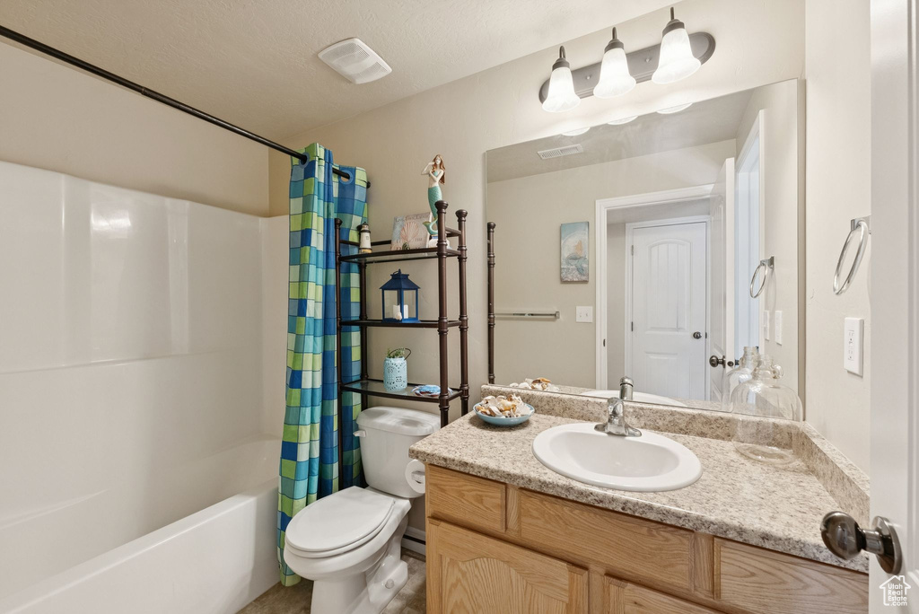 Full bath featuring vanity and shower / bath combo