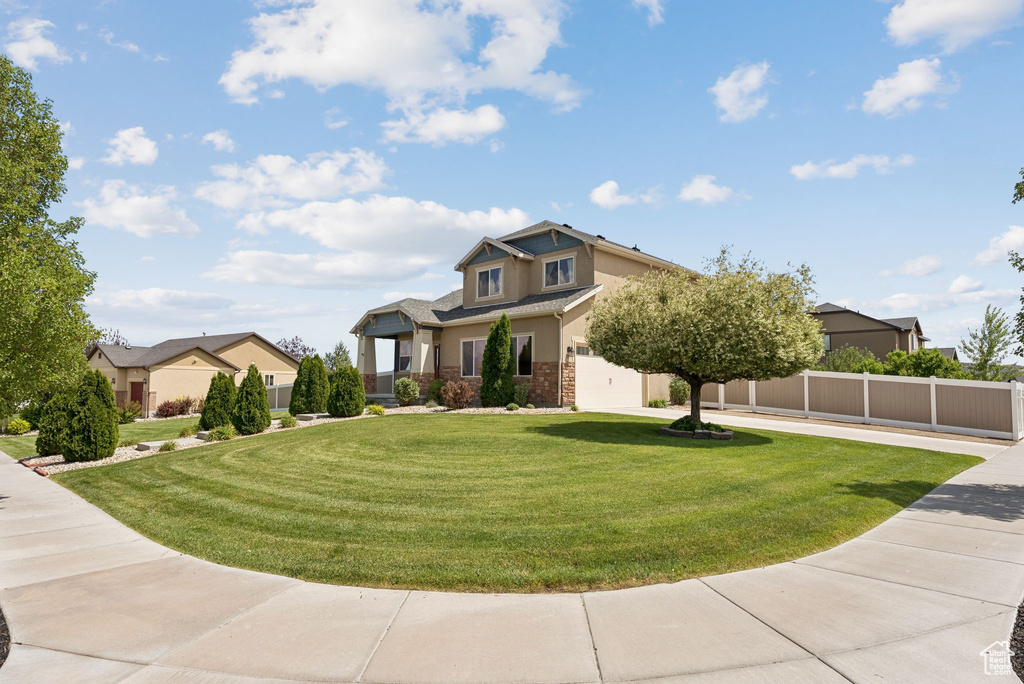 View of front of house featuring stucco siding and brick siding