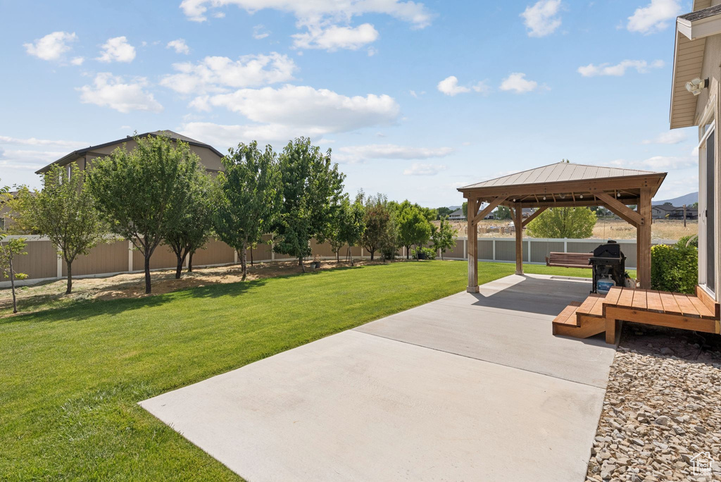 Fenced backyard with a gazebo and a patio area