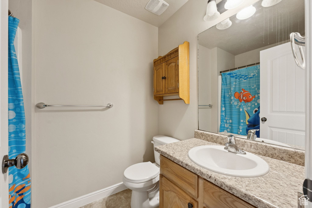 Bathroom featuring vanity, tile patterned flooring, and a shower with shower curtain