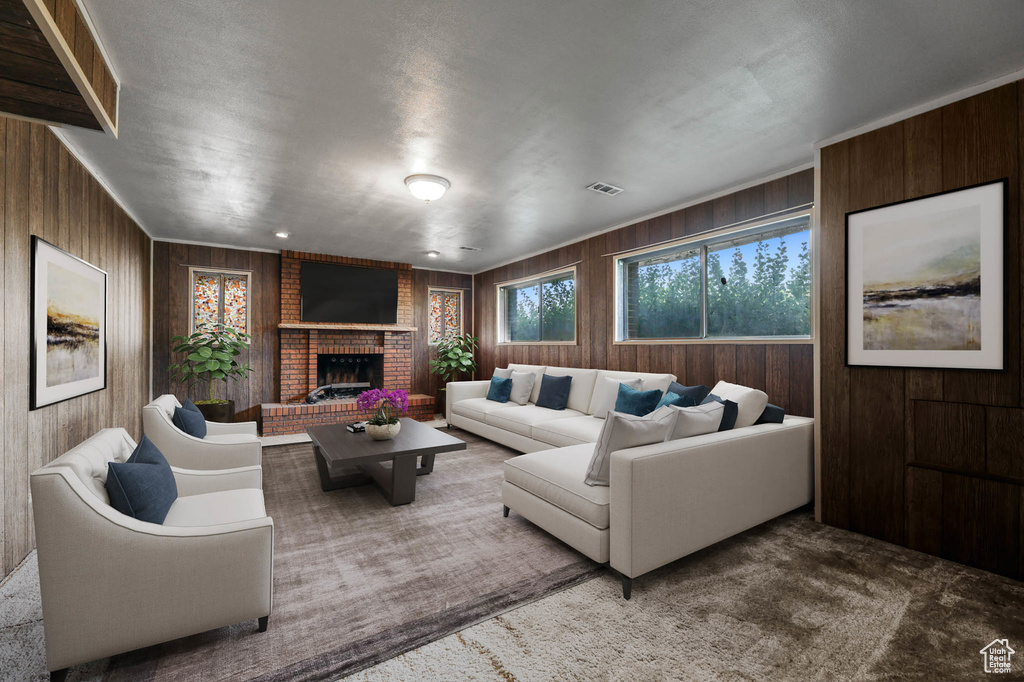 Living room with wood walls, a fireplace, and carpet