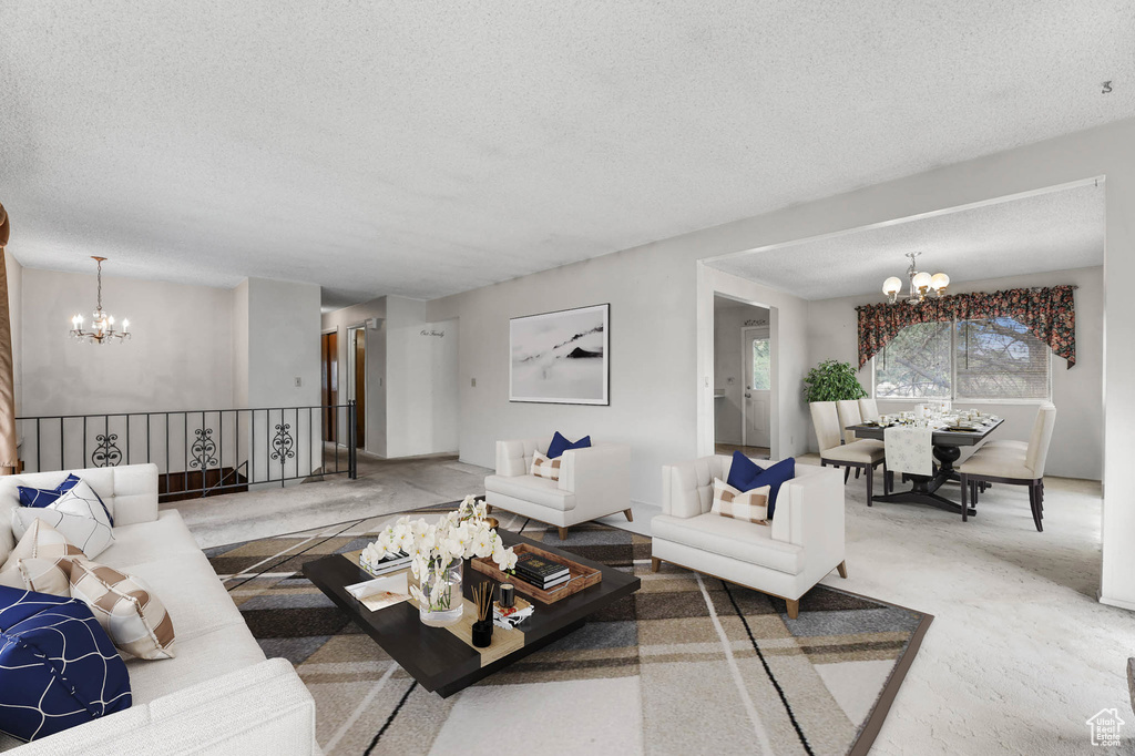 Living room with a chandelier, a textured ceiling, and carpet flooring