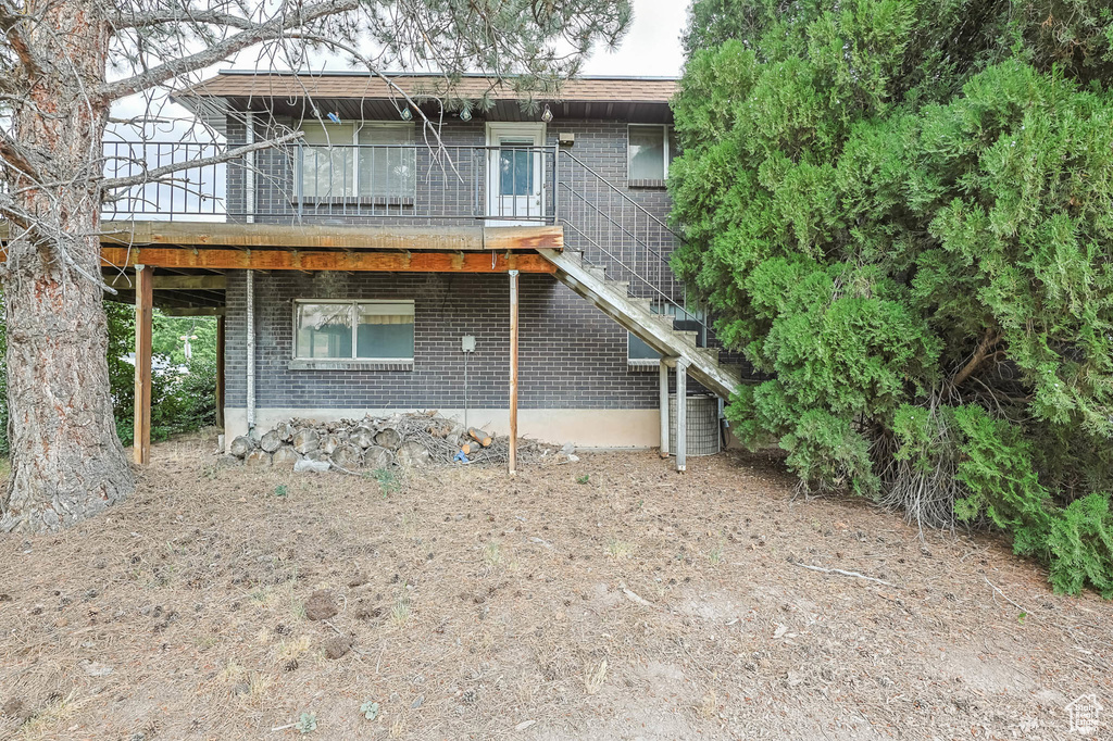 Back of property with brick siding and stairway
