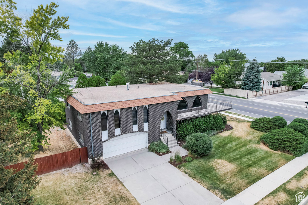View of front of house with driveway and brick siding