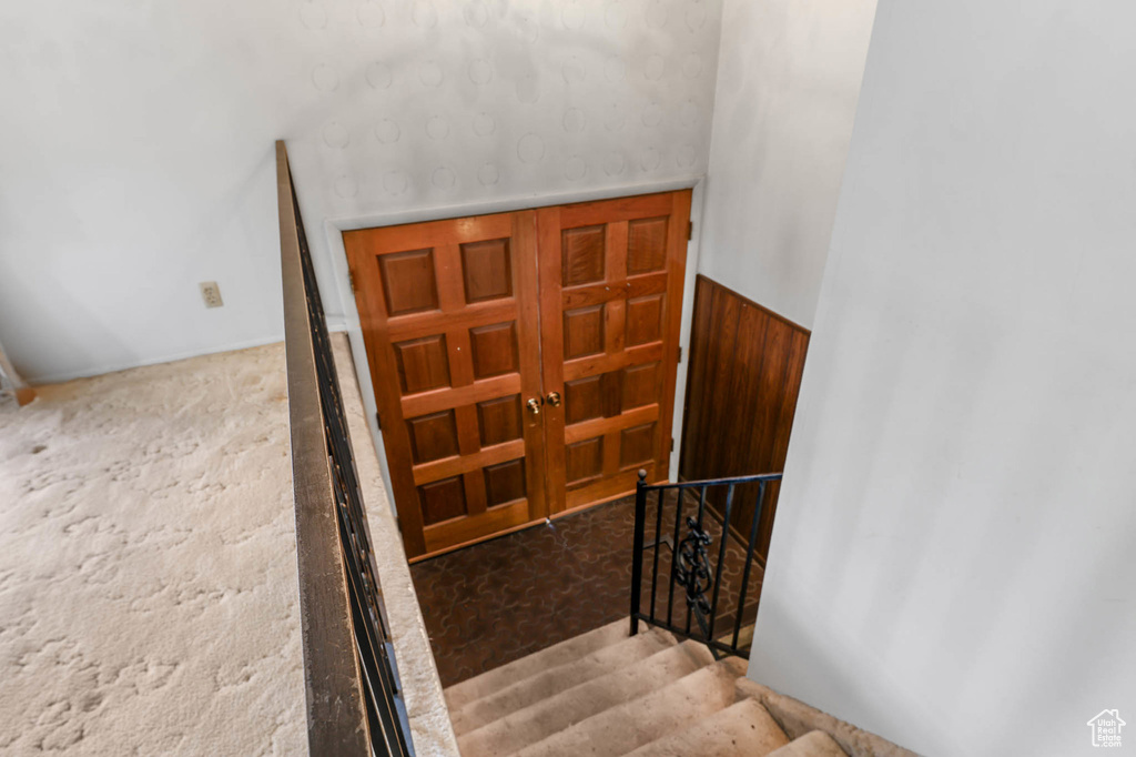 Stairs featuring carpet floors and french doors