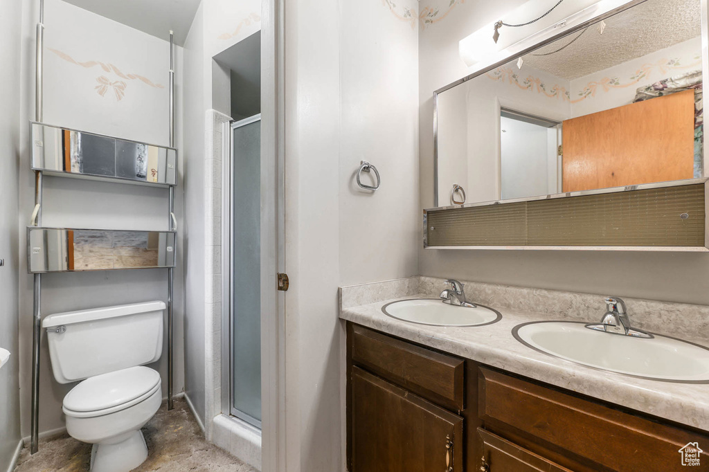 Bathroom with a shower stall and double vanity
