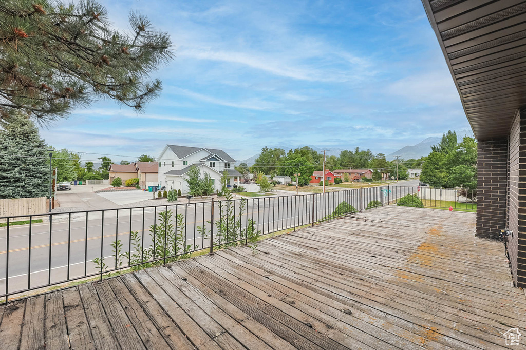 Deck featuring a residential view and a mountain view