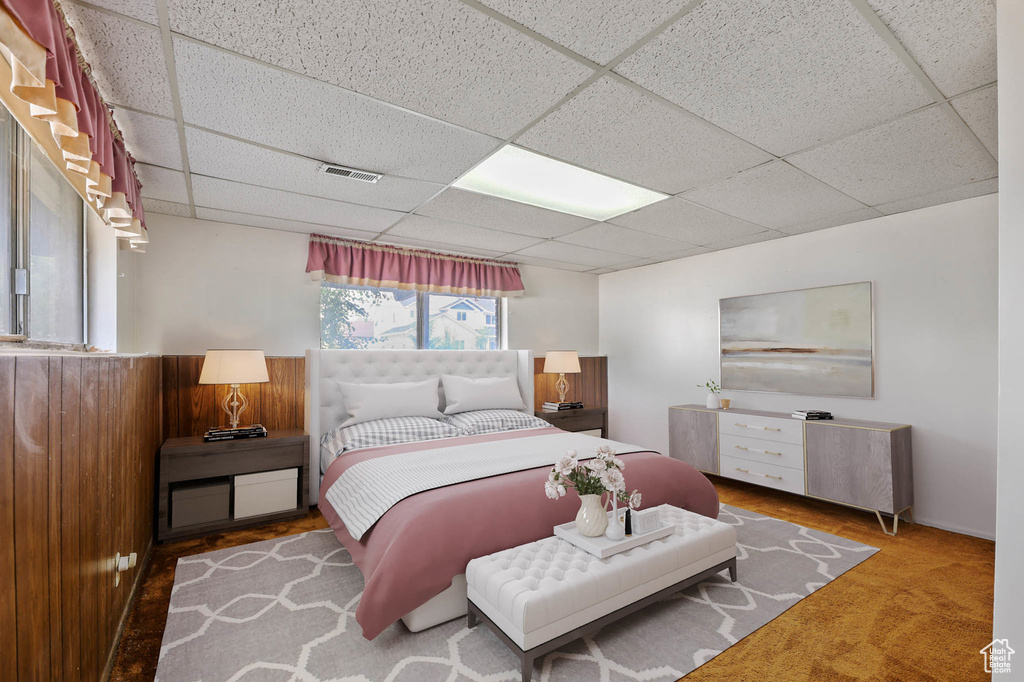 Carpeted bedroom with a paneled ceiling
