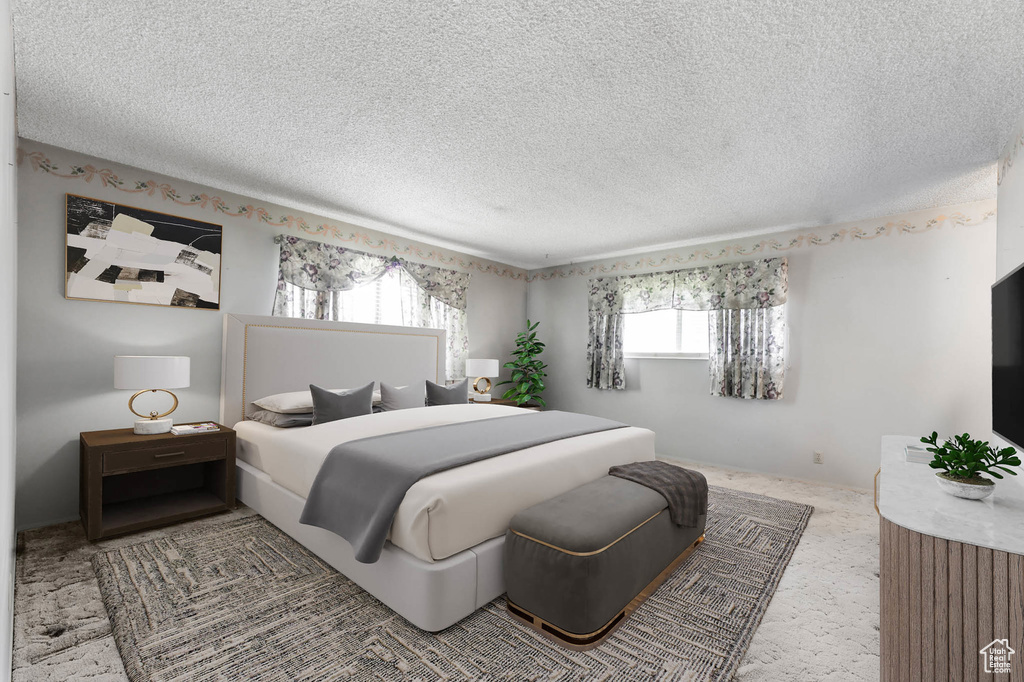 Carpeted bedroom with a textured ceiling
