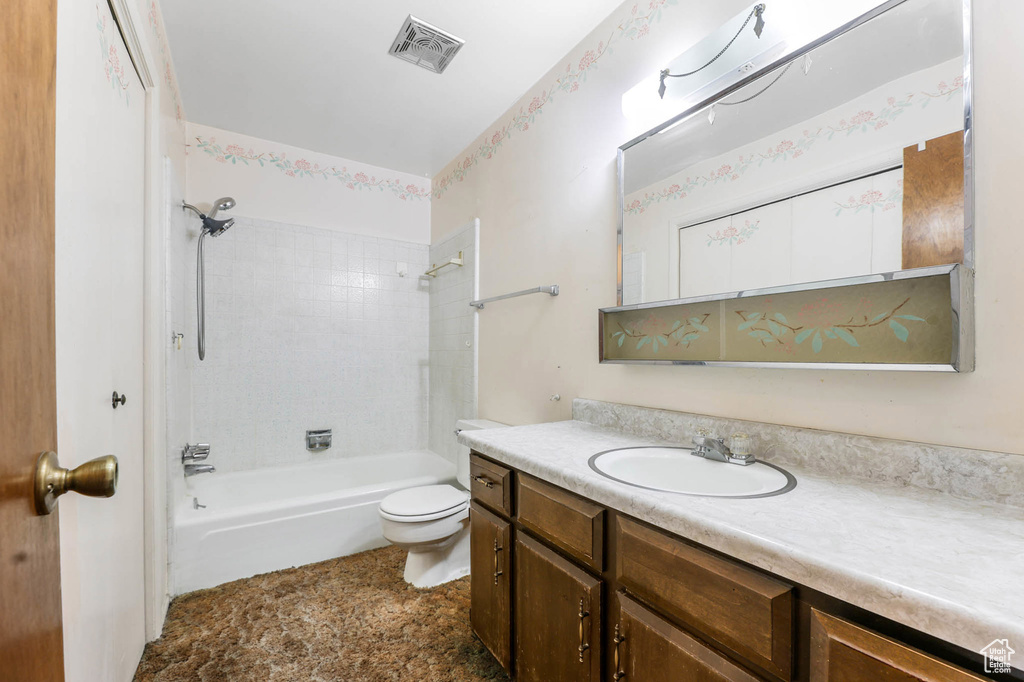 Bathroom featuring vanity and  shower combination