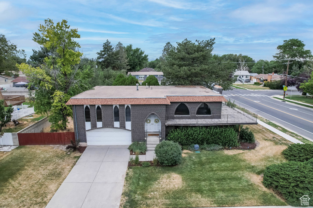 View of front of home with concrete driveway and brick siding