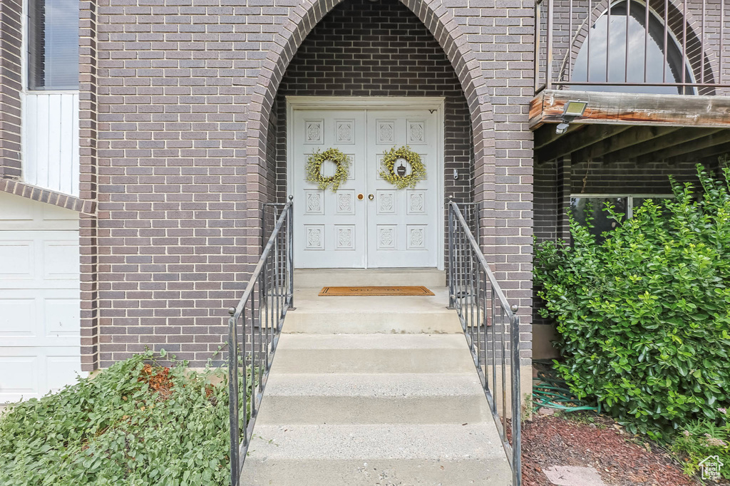 Doorway to property with brick siding