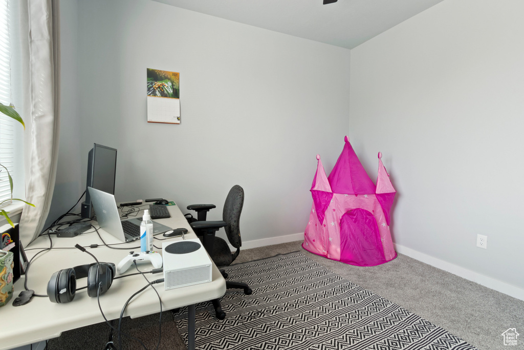 Home office featuring carpet and baseboards