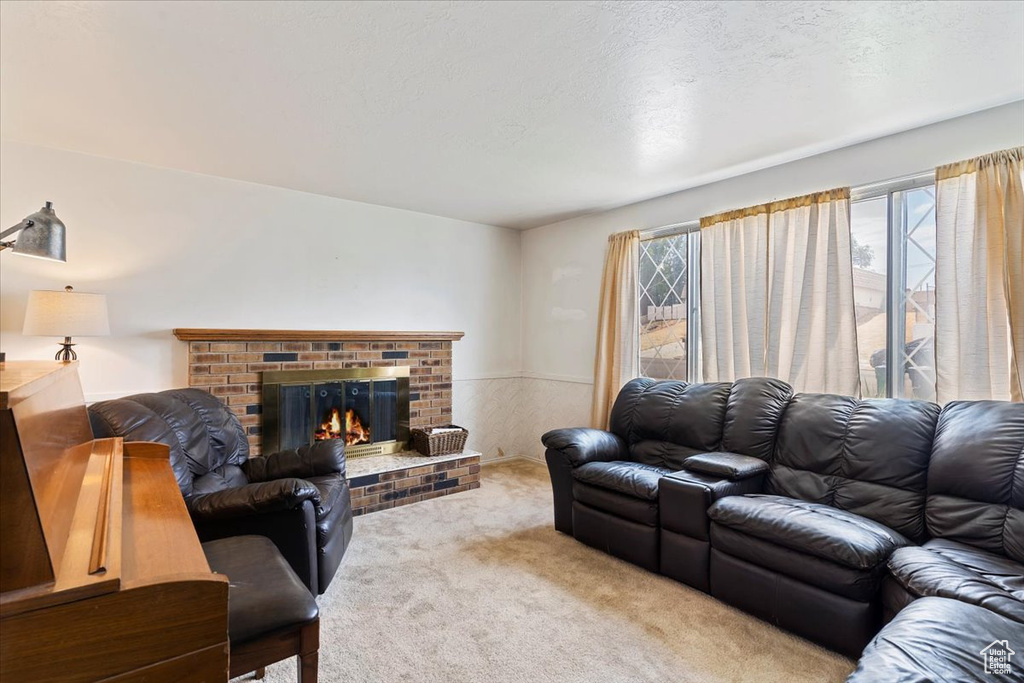 Living room with carpet and a brick fireplace