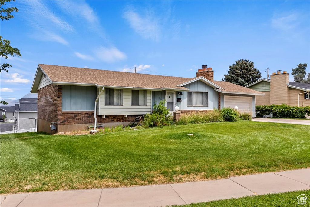 Ranch-style house with driveway, a garage, brick siding, a chimney, and roof with shingles