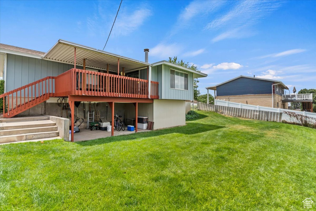 Rear view of house with a patio, a wooden deck, and stairway
