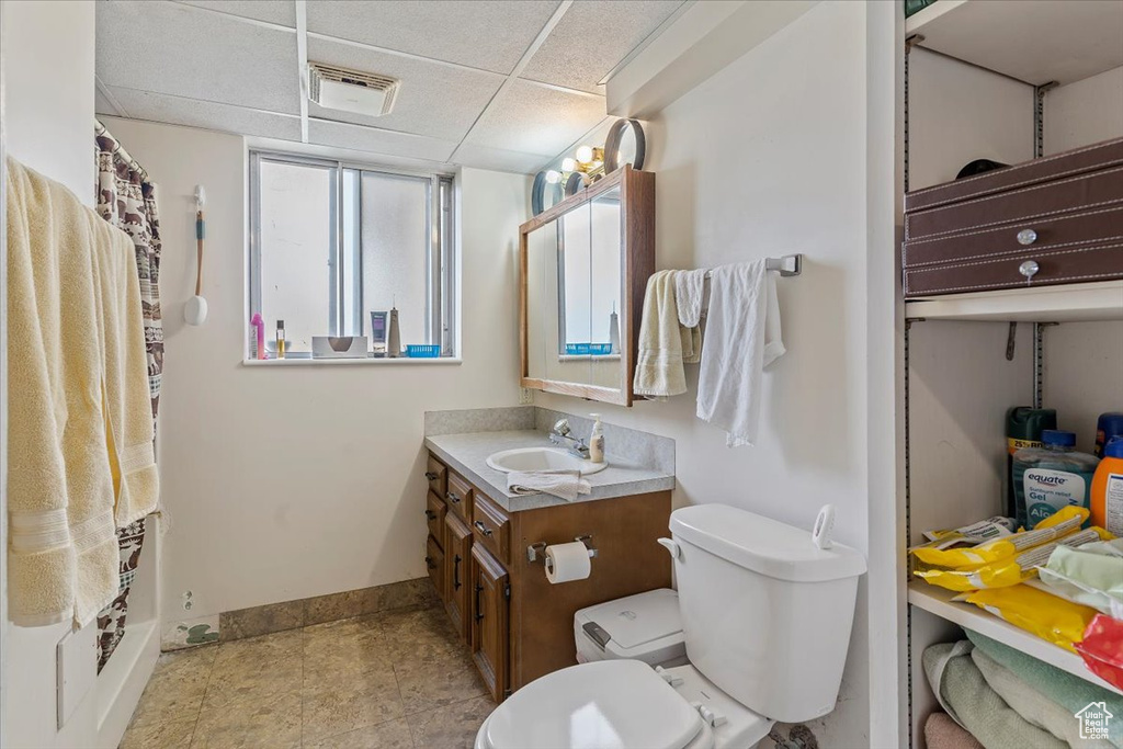 Full bath with vanity and a drop ceiling
