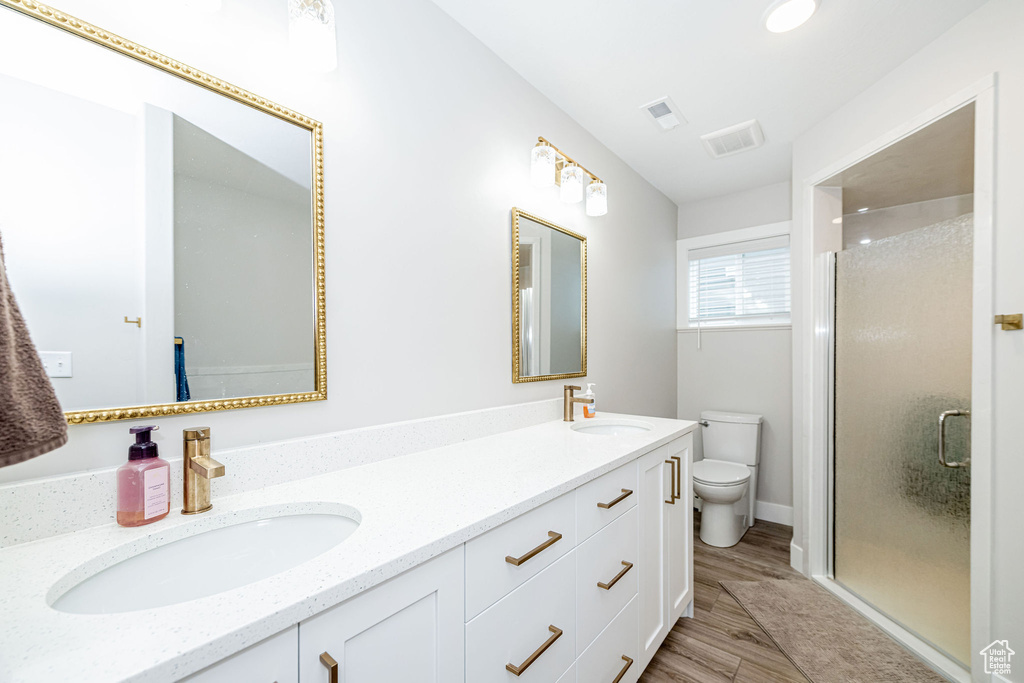 Bathroom featuring double vanity and a stall shower