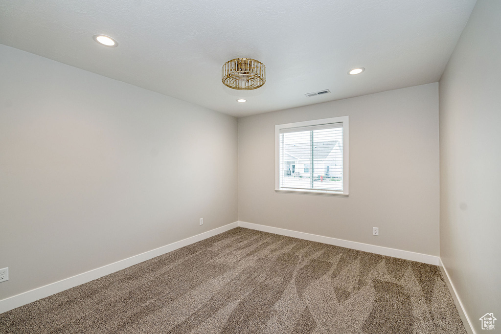 Empty room featuring carpet and recessed lighting