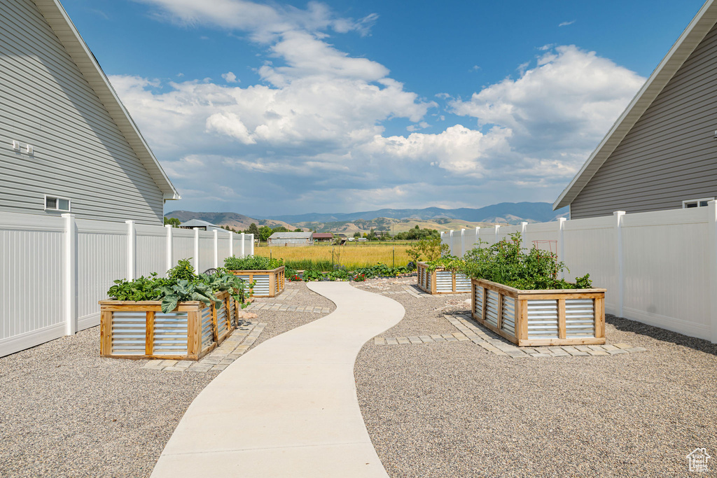 View of patio with a garden and a mountain view