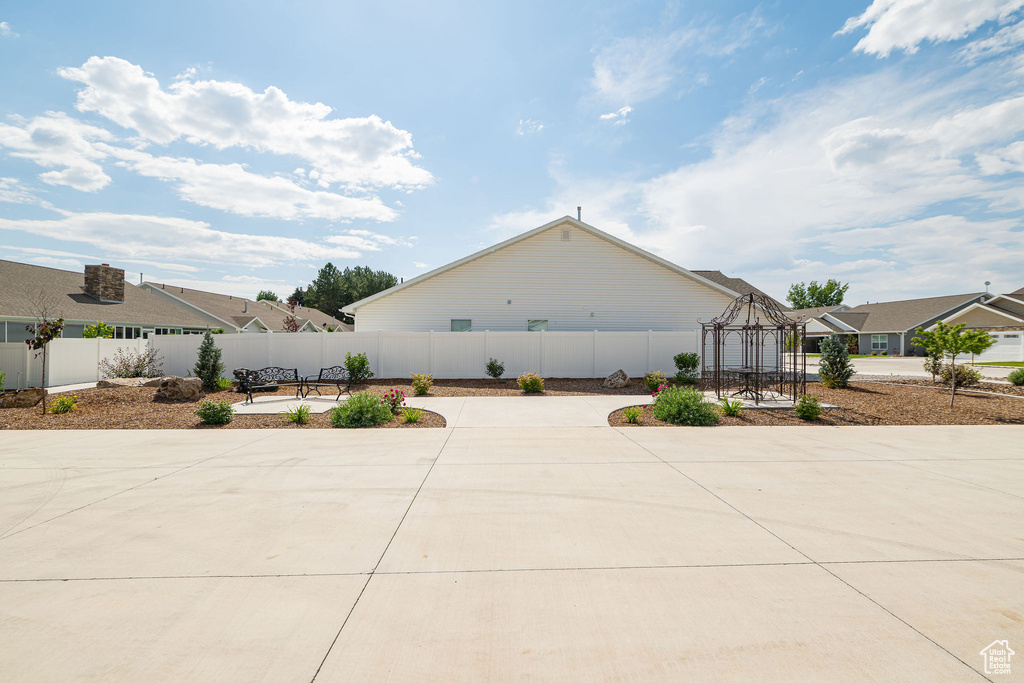 View of side of home featuring a patio area and a gazebo