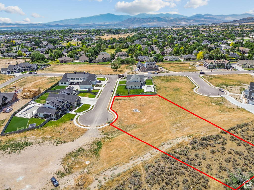 Aerial view of residential area featuring property parcel outlined and mountains