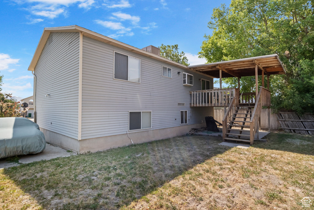 Back of house with stairs and a wooden deck