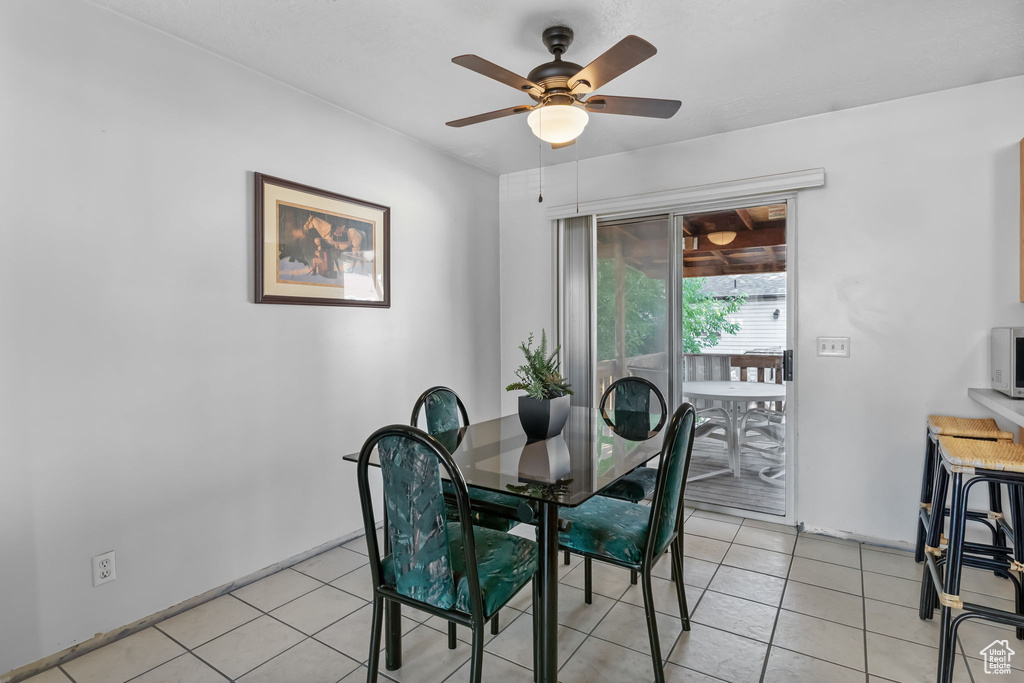 Dining area featuring ceiling fan and light tile patterned flooring
