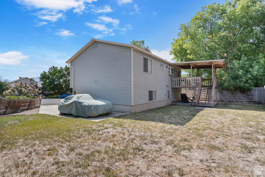 Back of property with stairway and a wooden deck