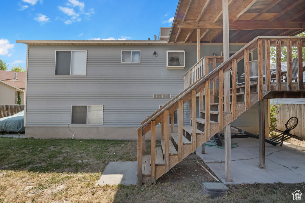 Rear view of house with stairway and a patio